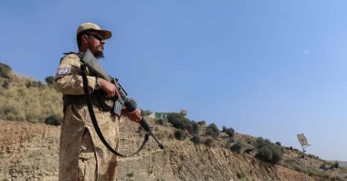 A Taliban security personnel stands guard along a road near the Ghulam Khan zero-point border crossing between Afghanistan and Pakistan in Gurbuz district in the southeast of Khost province, Oct. 20, 2025. (AFP Photo)