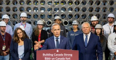 Canada&#039;s Prime Minister Mark Carney speaks as President and CEO of Ontario Power Generation (OPG), Nicolle Butcher, and Ontario Premier Doug Ford listen during a press conference in front of a mock reactor at the Darlington Energy Complex in Courtice, Ontario, Canada, Oct. 23, 2025. (Reuters Photo)
