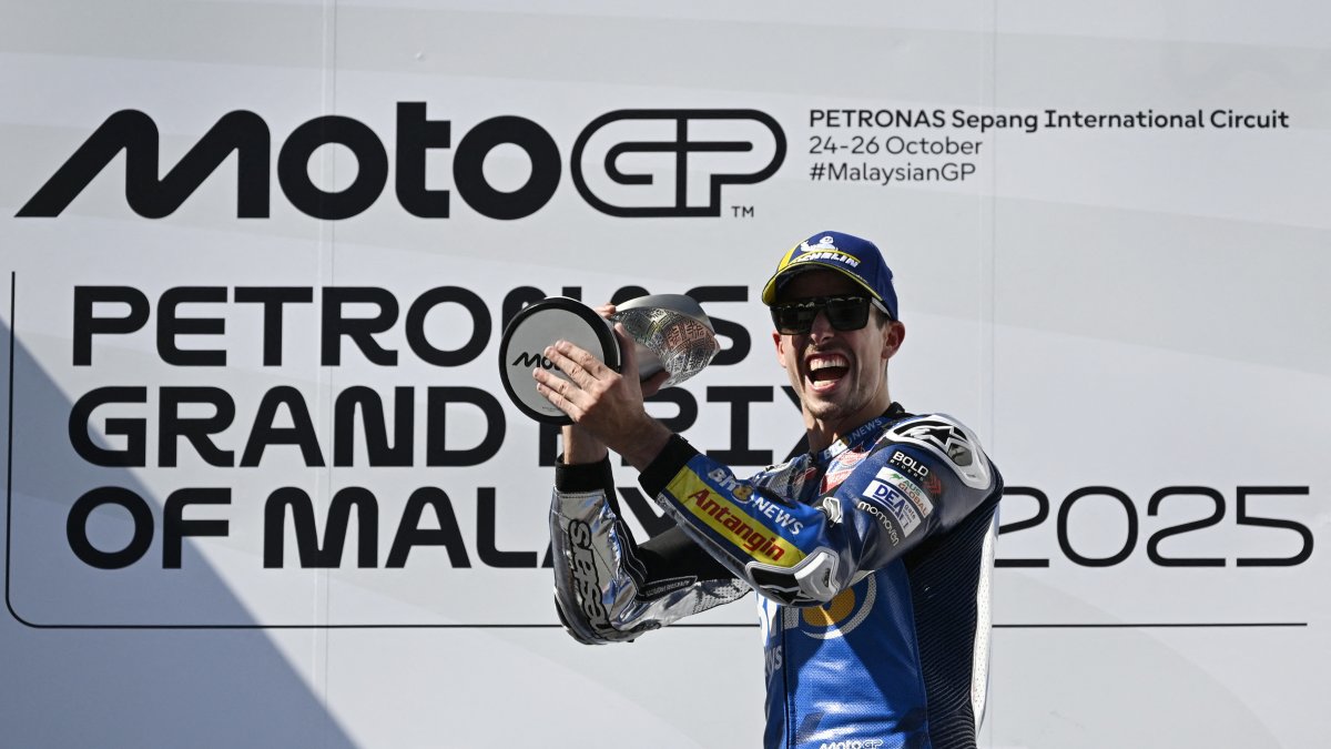 BK8 Gresini Racing MotoGP&#039;s Alex Marquez celebrates on the podium with the trophy after winning the Malaysian MotoGP race, Sepang, Malaysia, Oct. 26, 2025. (Reuters Photo)