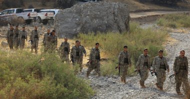 PKK terrorists walk during a disarmament ceremony in an undisclosed location in Iraq, Oct. 26, 2025. (Reuters Photo)
