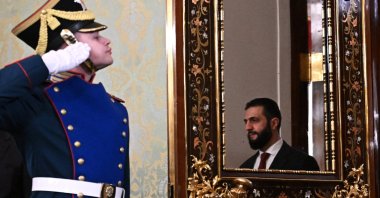 Syrian President Ahmed al-Sharaa is reflected in a mirror as he enters a hall before a meeting with Russian President Vladimir Putin at the Kremlin, Moscow, Russia, Oct. 15, 2025. (EPA Photo)