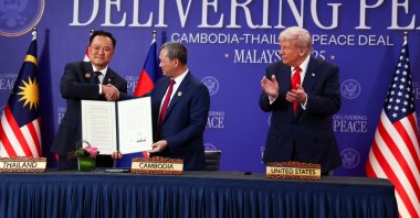 Thailand&#039;s Prime Minister Anutin Charnvirakul (L) and Cambodia’s Prime Minister Hun Manet shake hands and hold up a cease-fire document, while U.S. President Donald Trump applauds, in Kuala Lumpur, Malaysia, Oct. 26, 2025. (Reuters Photo)
