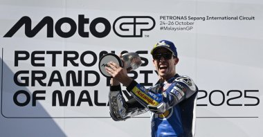 BK8 Gresini Racing MotoGP&#039;s Alex Marquez celebrates on the podium with the trophy after winning the Malaysian MotoGP race, Sepang, Malaysia, Oct. 26, 2025. (Reuters Photo)