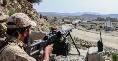 A Taliban security personnel stands guard along a road near the Ghulam Khan zero-point border crossing between Afghanistan and Pakistan in Gurbuz district in the southeast of Khost province, Afghanistan, Oct. 20, 2025. (AFP Photo)