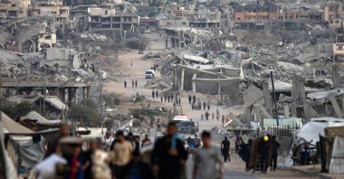 Palestinians walk among the ruins of their homes destroyed by Israeli bombardment, in Khan Younis, southern Gaza Strip, Oct. 25, 2025. (EPA Photo)