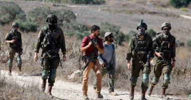 Israeli settlers and soldiers prevent Palestinians and foreign activists from accessing olive trees during olive harvest, in the village of Tell, near Nablus, in the Israeli-occupied West Bank, Oct. 20, 2025. (Reuters Photo)