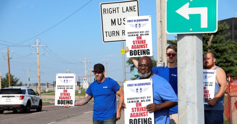 Workers hold signs during a walkout by members of the International Association of Machinists and Aerospace Workers (IAM) over contract negotiations, outside Boeing company's facility, in Berkeley, Missouri, U.S., Aug. 4, 2025. (Reuters Photo)