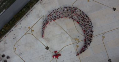 People form a crescent and star, symbols in the Turkish flag, for a Republic Day event, Eskişehir, central Türkiye, Oct. 26, 2025. (AA Photo)