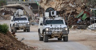 U.N. peacekeepers drive in past destroyed buildings while patrolling in Lebanon&#039;s southern village of Kfar Kila close to the border with Israel, April 6, 2025. (AFP Photo)