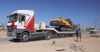 Heavy equipment is transported into the Gaza Strip heading to one of the sites to begin work in the recovery of the bodies of Israeli hostages, east of Deir al-Balah, central Gaza Strip, Palestine, Oct. 27, 2025. (AFP Photo)