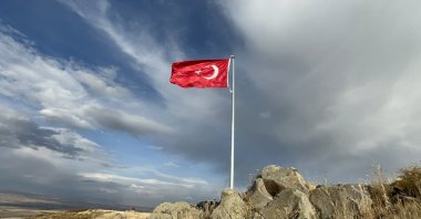 A Turkish flag waves on top of a hill, Kars, Türkiye, Oct. 26, 2025. (İHA Photo)