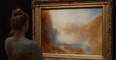 Curator of British Art Dr. Melissa Gustin poses with &quot;The Falls of the Clyde&quot; by JMW Turner during a press preview for &quot;Turner: Always Contemporary&quot; at the Walker Art Gallery, Liverpool, U.K., Oct. 23, 2025. (EPA Photo)