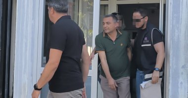 Police officers escort Manavgat Mayor Niyazi Nefi Kara after his detention, Antalya, Türkiye, July 8, 2025. (IHA Photo)