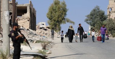 Syrian civilians move to safe places after clashes between Syrian security forces and the YPG terrorist group, Aleppo, Syria, Oct. 7, 2025. (AA Photo)