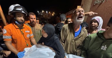 A Palestinian man reacts next to the body of a man, who according to medics was killed in an Israeli strike, at Nasser Hospital in Khan Younis, southern Gaza Strip, Oct. 28, 2025. (Reuters Photo)