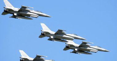 F-16 fighter jets fly in the sky over Poland&#039;s capital as they take part in a military parade, in Warsaw, Poland, Aug. 15, 2023. (AP Photo)