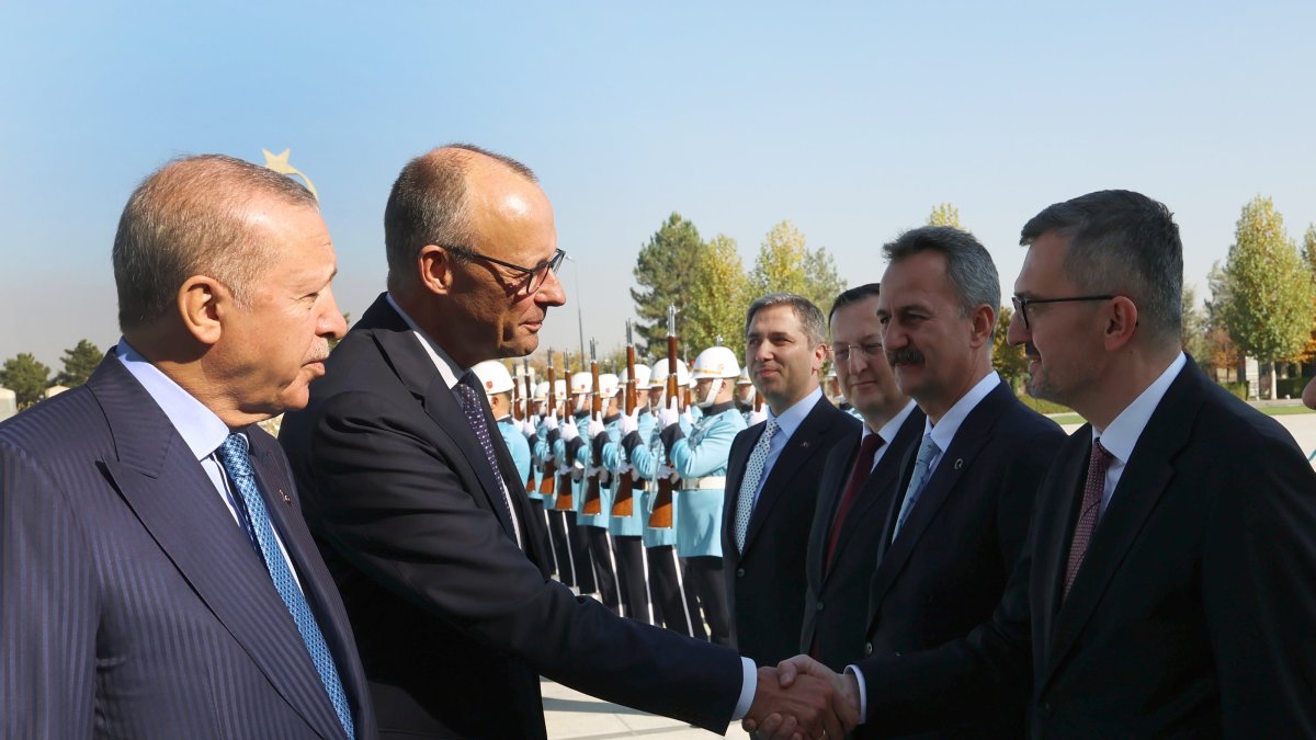 Presidential Communications Director Burhanettin Duran and German Chancellor Friedrich Merz shake hands at the Presidential Complex in Ankara, Oct. 30, 2025. (AA Photo)