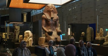 Visitors pose for a group photo under the Hatshepsut statue, at the Grand Egyptian Museum, Giza, Egypt, May 23, 2025. (AP Photo)