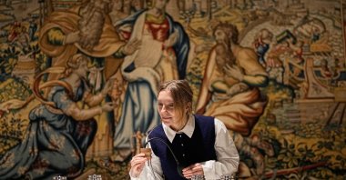 A woman smells a medieval scent probe during the exhibition &quot;The Secret Power of Scents,&quot; showing the history of scent from antiquity to the present as a sensory experience at the Kunstpalast art museum, Düsseldorf, Germany, Oct. 28, 2025. (AP Photo)