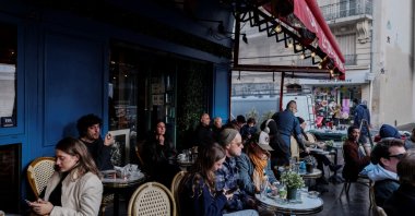 People sit at outdoor tables of a cafe, Paris, France, Oct. 26, 2025. (Reuters Photo)