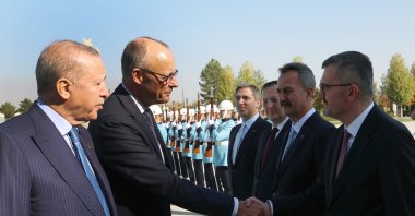 Presidential Communications Director Burhanettin Duran and German Chancellor Friedrich Merz shake hands at the Presidential Complex in Ankara, Oct. 30, 2025. (AA Photo)