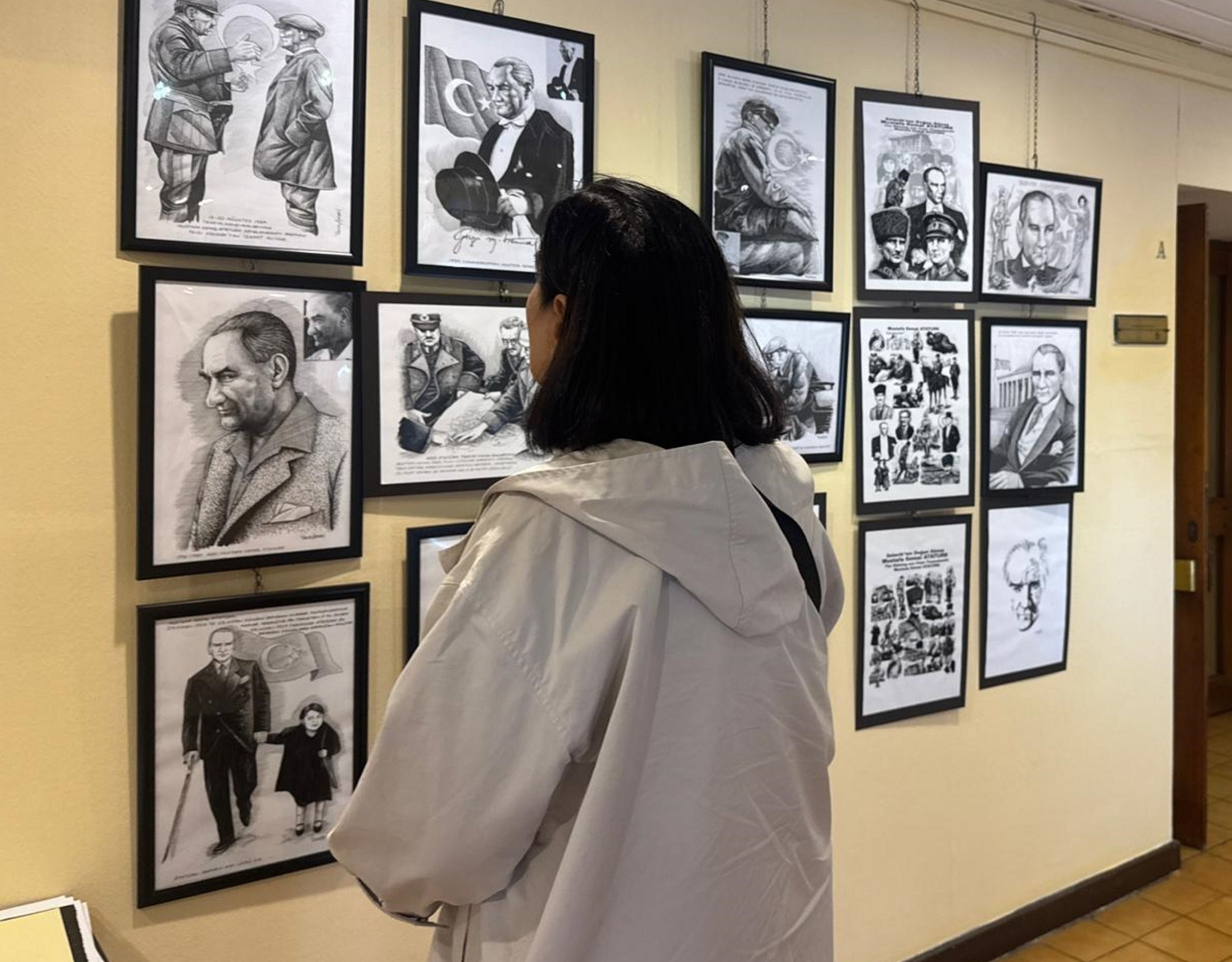 A visitor views the charcoal drawings at the TGC Press Media Museum, Istanbul, Türkiye, Oct. 30, 2025. (AA Photo)