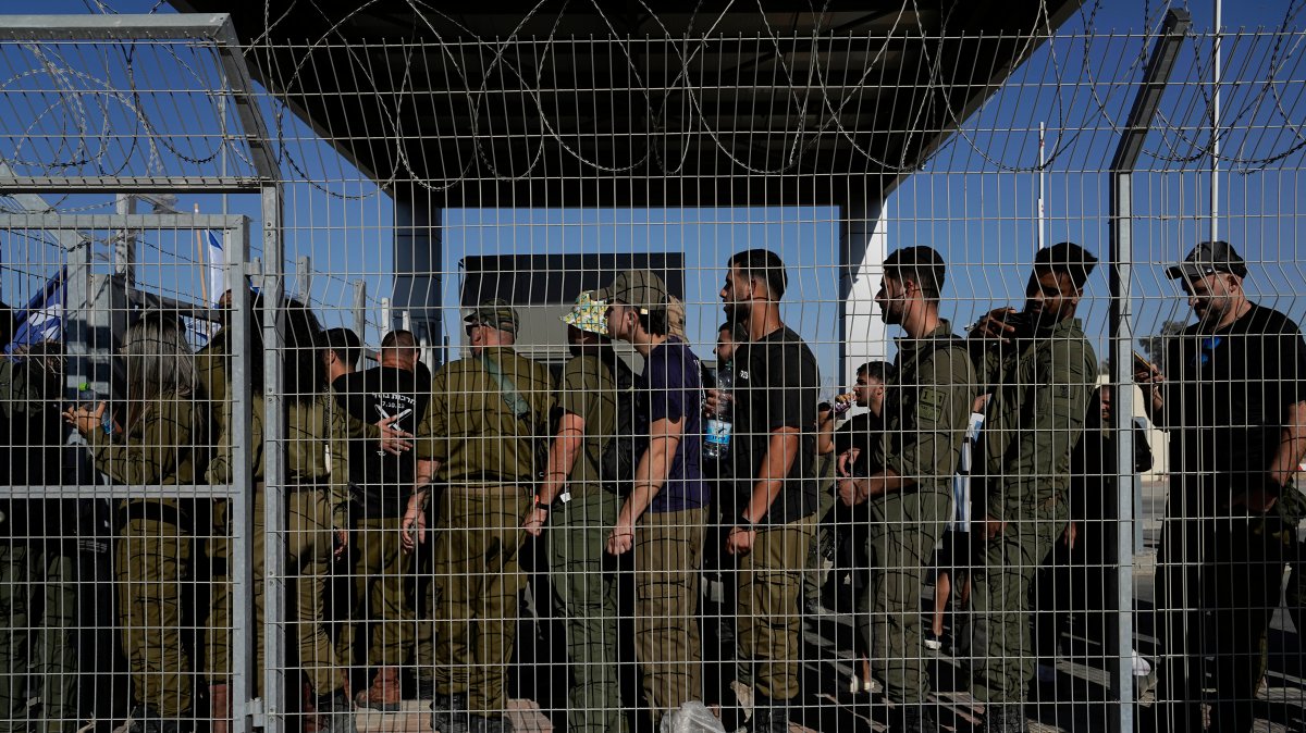 Israeli soldiers gather at the gate to the Sde Teiman military base, as people protest in support of soldiers being questioned for detainee abuse, July 29, 2024. (AP File Photo)
