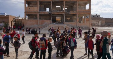 Students gather in the yard of a damaged school, Idlib countryside, Syria, Oct. 9, 2025. (Reuters Photo)