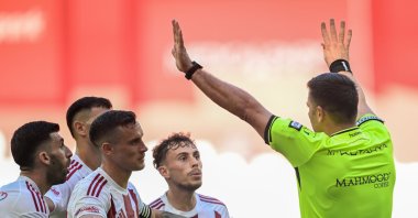 Antalyaspor players protest referee Ümit Öztürk in the game with RAMS Başakşehir at Corendon Airlines Park, Antalya Stadium, Oct. 31, 2025. (AA Photo)