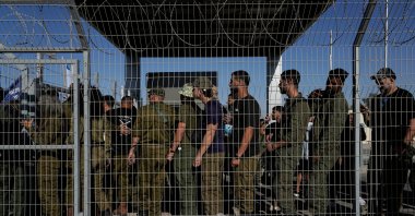 Israeli soldiers gather at the gate to the Sde Teiman military base, as people protest in support of soldiers being questioned for detainee abuse, July 29, 2024. (AP File Photo)