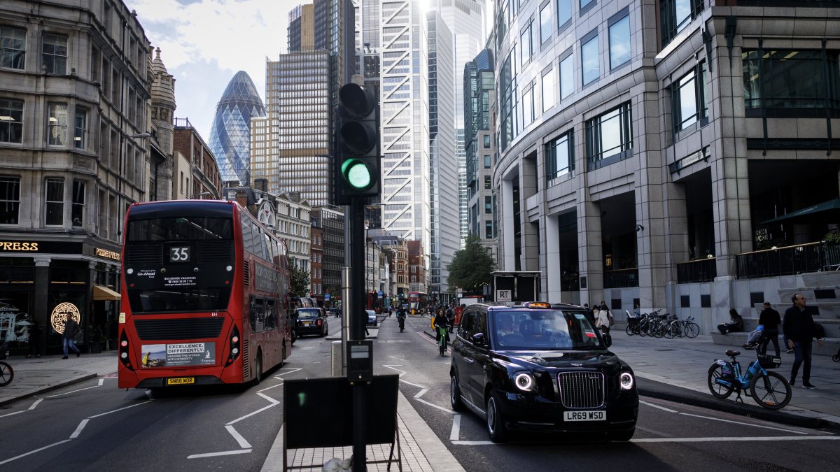 A double-decker bus and a black cab taxi drive in the City of London financial district of London, U.K., Oct. 21, 2025. (EPA Photo)