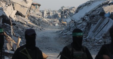 Fighters of the Al-Qassam Brigades, the military wing of the Hamas movement, stand guard as they search for the bodies of Israeli hostages alongside Red Cross workers in the east of the Gaza Strip, Nov. 2, 2025. (AA Photo)