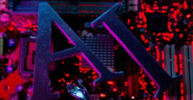 The letters AI (Artificial Intelligence) and a robot hand are placed on a computer motherboard in this illustration, June 23, 2023. (Reuters File Photo)