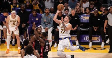 Los Angeles Lakers guard Luka Doncic (R) goes for a layup against Miami Heat defenders during an NBA game at Crypto.com Arena, Los Angeles, U.S., Nov. 3, 2025. (AA Photo)
