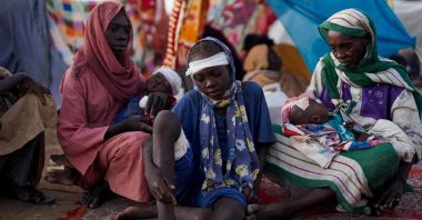 Ikram Abdelhameed looks on next to her family while sitting at a camp for displaced people who fled from al-Fashir to Tawila, North Darfur, Sudan, Oct. 27, 2025. (Reuters Photo)