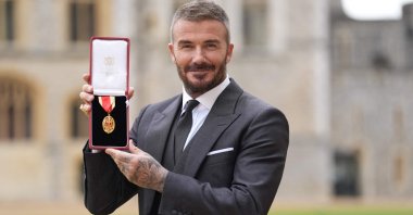 Former England footballer David Beckham poses with his medal after being appointed as a Knight Bachelor (Knighthood) for services to sport and charity at an investiture ceremony at Windsor Castle, London, U.K., Nov. 4, 2025. (AFP Photo)