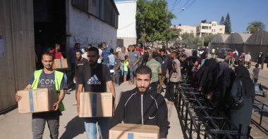 Food boxes provided by the World Food Programme (WFP) are collected by Palestinians at a distribution centre in the village of Al-Zawayda, in the centre of the Gaza Strip, Oct. 27, 2025. (AFP File Photo)
