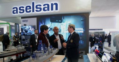 People chat at the ward of Turkish defense company Aselsan, during Exponaval 2024, Valparaiso, Chile, Dec. 3, 2024. (Reuters Photo)