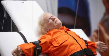 This photograph shows the art piece by British artist Mason Storm called &quot;Saint or Sinner,&quot; depicting U.S. President Donald Trump dressed in an orange prison jumpsuit on a cross, displayed at an exhibition space, Basel, Switzerland, Nov. 3, 2025. (AFP Photo)