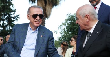 President Recep Tayyip Erdoğan and MHP leader Devlet Bahçeli chat during an event, Istanbul, Türkiye, July 15, 2022. (AA Photo)