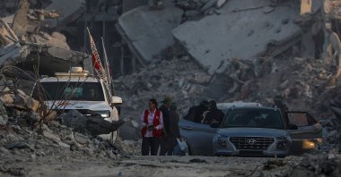 Fighters of the Al-Qassam Brigades, the military wing of the Hamas movement, stand guard as they search for the bodies of Israeli hostages alongside Red Cross workers in Al Shejaeiya neighbourhood in the east of the Gaza City, Gaza Strip, Nov. 5, 2025. (EPA Photo)