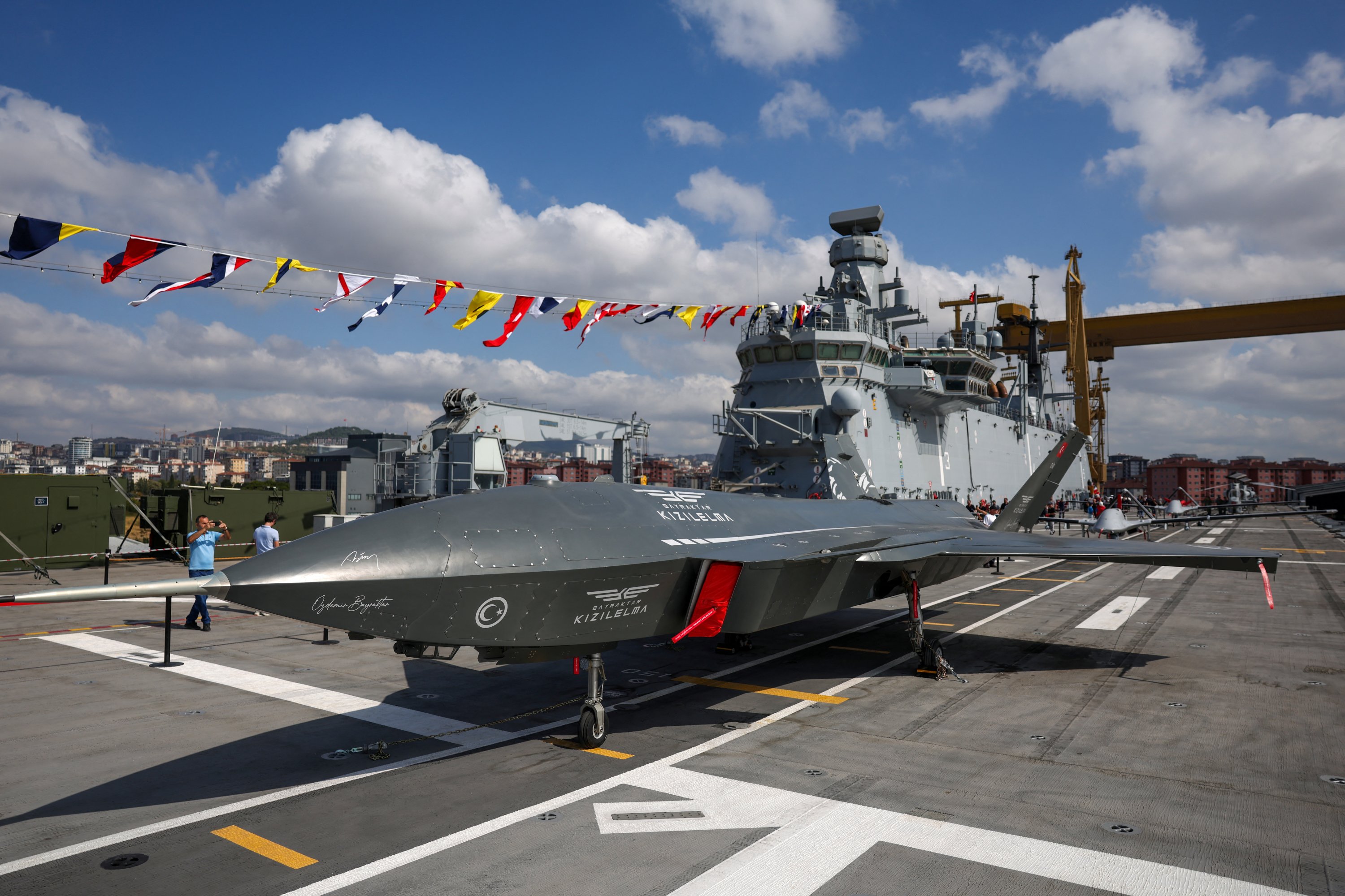 Kızılelma, an unmanned fighter aircraft developed by Turkish defense firm Baykar, stands on the deck of the TCG Anadolu, Türkiye's first amphibious assault ship, alongside other drones and army helicopters during the Teknofest Blue Homeland event at the Naval Shipyard Command, Istanbul, Türkiye, Aug. 29, 2025. (Reuters Photo)