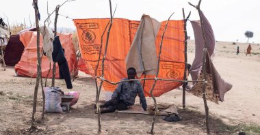 A displaced Sudanese man who fled el-Fasher after the city fell to the RSF, sits in a makeshift shelter in the Um Yanqur camp, located on the southwestern edge of Tawila, western Darfur region, Sudan, Nov. 3, 2025. (AFP Photo)