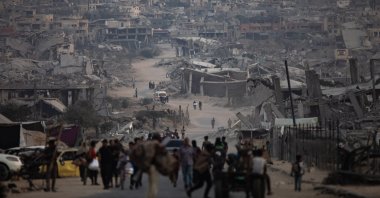 Displaced Palestinians sit next to their destroyed homes in Khan Younis camp in the southern Gaza Strip, Palestine, Nov. 5, 2025. (EPA Photo)