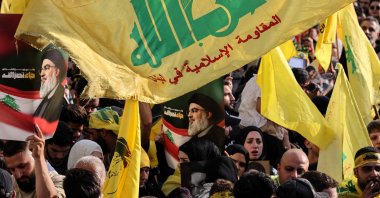 Hezbollah supporters raise the party&#039;s yellow flags and pictures of its slain leader, as they mark the first anniversary of his killing, in Beirut, Lebanon, Sept. 25, 2025. (AFP Photo)