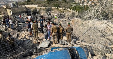 People and members of the Lebanese army gather at a damaged site in the aftermath of Israeli strikes, in Abbasiyyeh, Tyre district, southern Lebanon, Nov. 6, 2025. (Reuters Photo)
