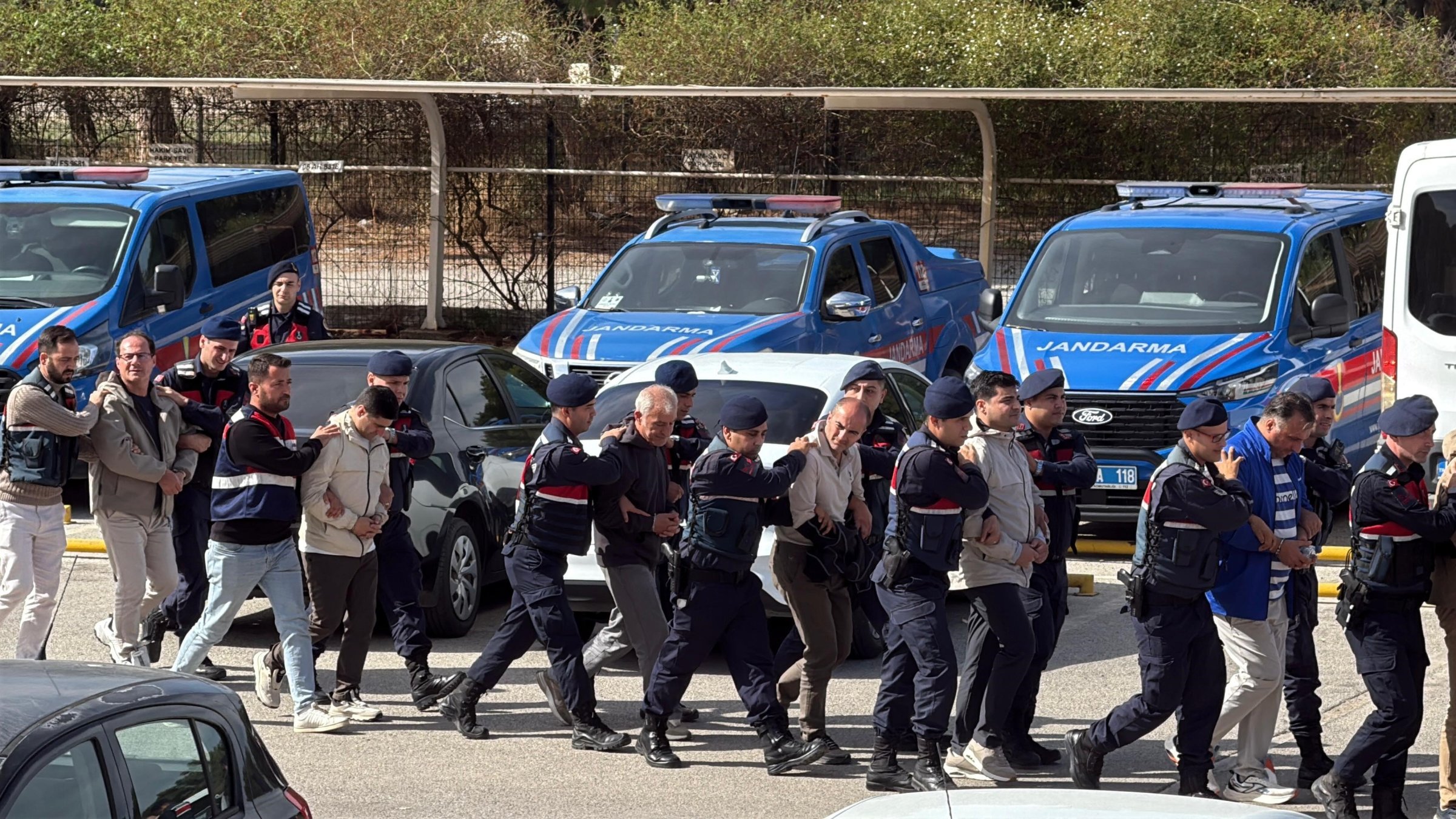 Security officers escort FETÖ suspects captured while trying to flee to Greece, Muğla, southwestern Türkiye, Nov. 1, 2025. (IHA Photo)