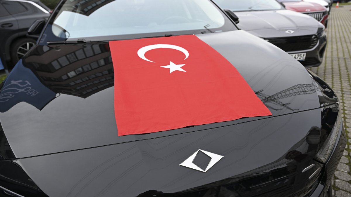 A T10F model of Türkiye’s Togg electric car with a Turkish flag is seen during a gathering in Stuttgart, Germany, Oct. 31, 2025. (AA Photo)