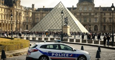 A police car parks in the courtyard of the Louvre museum, one week after the robbery, Paris, France, Oct. 26, 2025. (AP Photo)