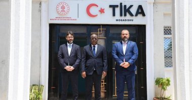 Türkiye’s Ambassador to Somalia Alper Aktaş (L) poses with Somali Information Minister Daud Aweys Jama (C) at TIKA&#039;s office, Mogadishu, Somalia, Oct. 26, 2025. (AA Photo)